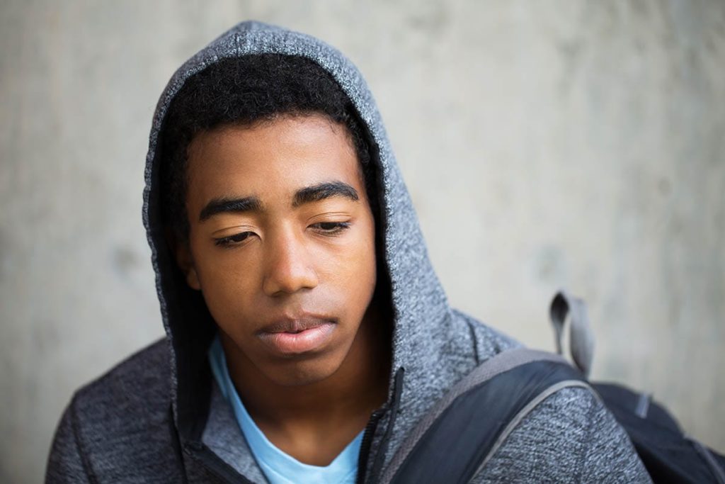 boy struggling with PTSD in teens