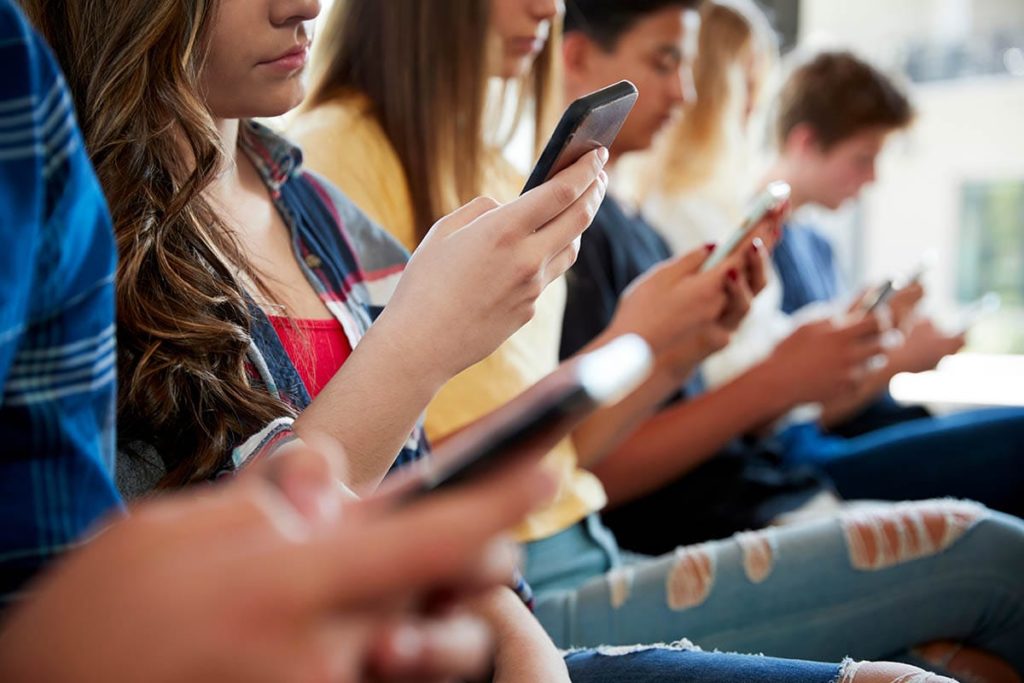 kids on phones learning about social media effects on teens