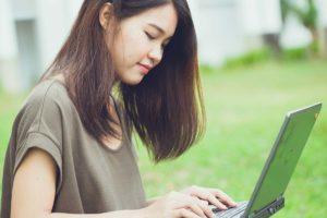 girl on laptop learning about teen bullying statistics