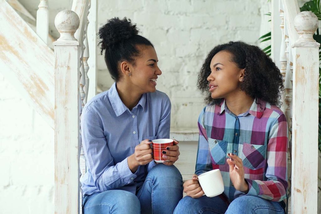 Two teens discussing cognitive-behavioral therapy techniques