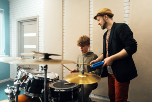 Two people trying different types of music therapy