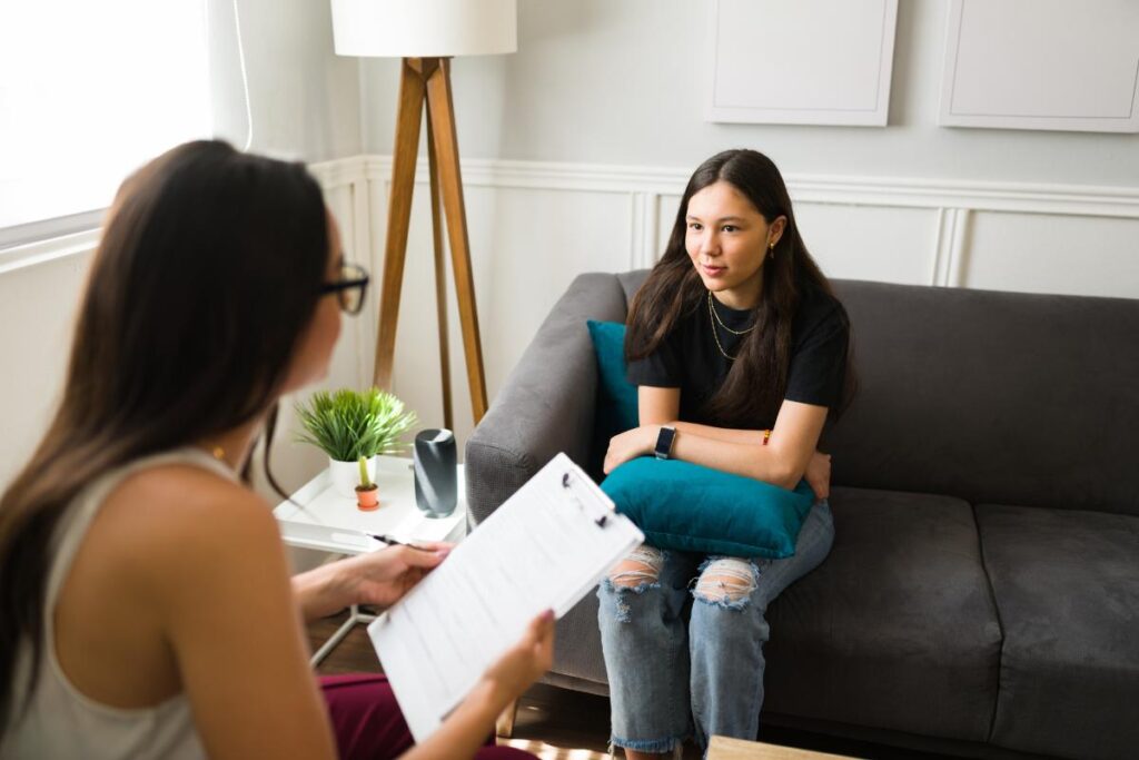 Two people talking about therapy topics for teens