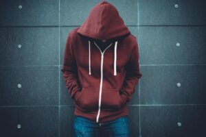 Person in hoodie showing signs of co-occurring disorders in teens