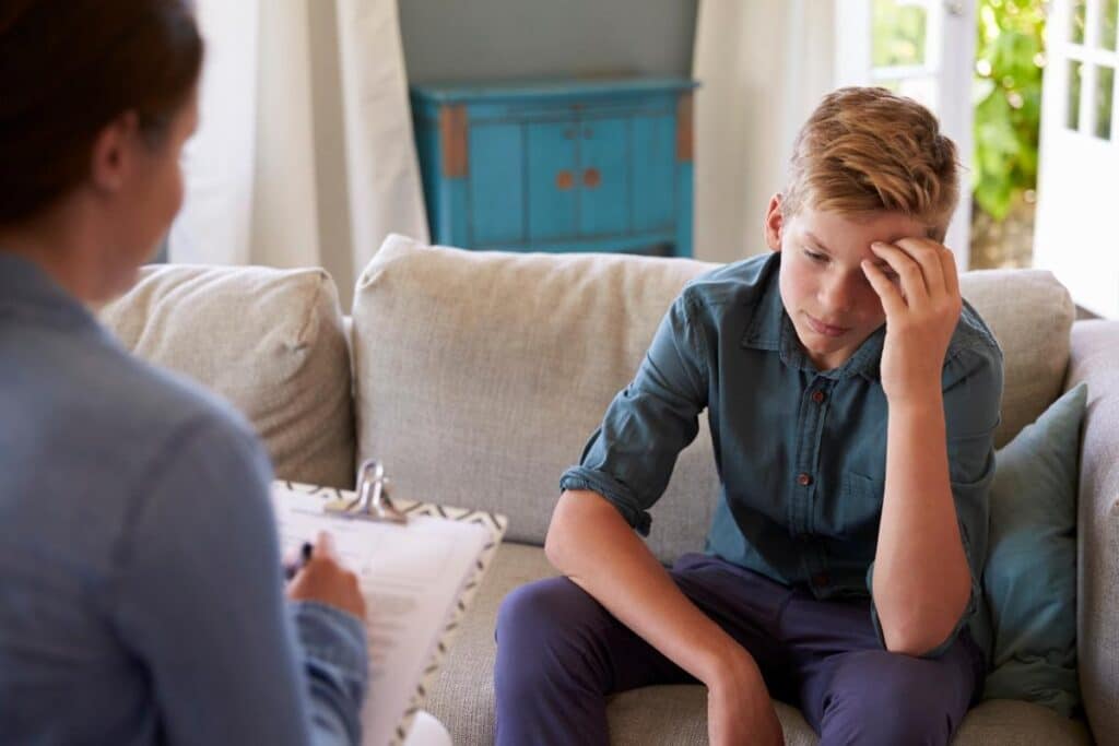 Person discussing the benefits of dialectical behavior therapy for depression with their therapist